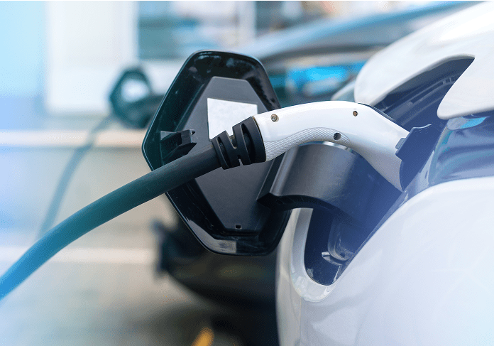 2 electric vehicles in the midst of charging, showing close-up charging port